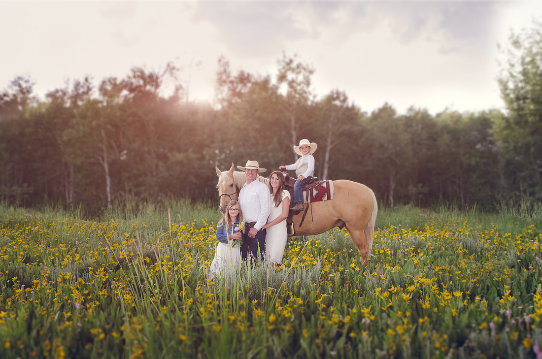 cowboy family in the wildflowers taken by Skylight Studio out of Pocatello Idaho