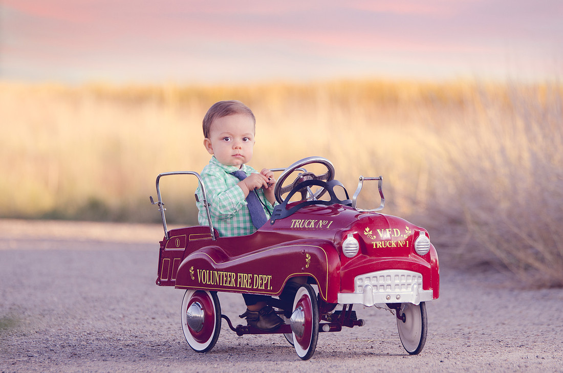 little boy in vintage fire truck from a family Portrait session by Sara Collier, Pocatello Idaho